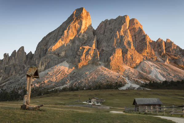 Sunset on the Peitlerkofel with a Wood crucifix and a little hut, Bolzano province, South Tyrol, Trentino Alto Adige, Italy