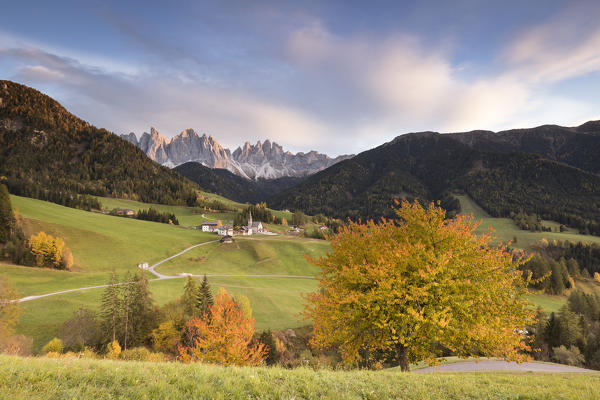 the typical autumnal sunset in Villnössertal with the famous alpine village and Geisler Group in the background, Bolzano province, South Tyrol, Trentino Alto Adige, Italy