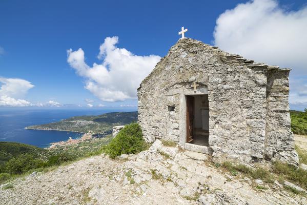 The Church of Holly Spirit (Crkva Sv. Duha) in the Hum mount, the village of Komiza at the bottom (Komiza, Vis Island, Split-Dalmatia county, Dalmatia region, Croatia, Europe)