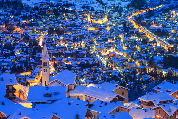 Europe, Italy, Lombardy, Sondrio. Bormio and Oga town after a winter snowfall in evening blue hour  