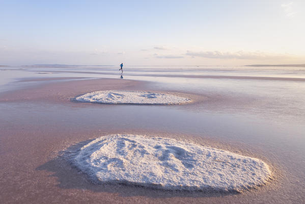 Running into the beaches of Tuz Golu salt lake with salt formations in foreground. Sereflikochisar, Ankara district, central Anatolia, Turkey.