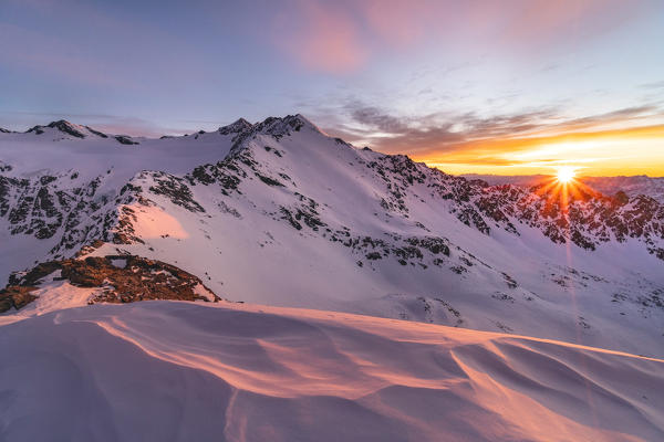 Mountain landscape from italian Alps during a winter sunrise. Vallombrina mount, Gavia pass, Santa Caterina Valfurva, Valtellina, Sondrio district, Lombardy, Italy, Europe.