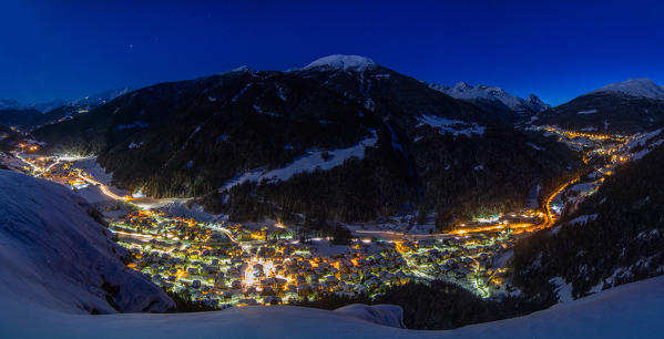 Night winter town lights in italian Alps. Isolaccia, Valtellina, Lombardy