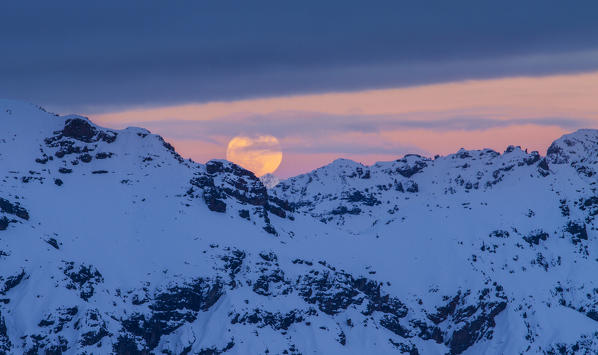 Europe, Italy, Lombardy. Moon sunset over Livigno mounts in the Lombardy italian Alps