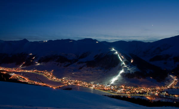 Livigno ski slopes lit a winter night. Valtellina - Lombardy