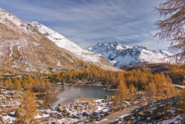 A small lake in Valtellina mountains with yellow autumnal clours. Valgrosina - Lombardy - Italian Alps