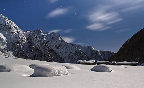 Full moon night in Rezzalo valley into the Stelvio National Park during winter snow season