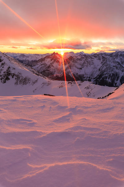 Red light of sunset from the summit of Vallecetta Peak. Bormio, Sondrio district, Lombardy, Italy