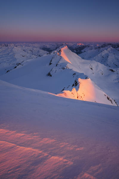Red light of sunrise from the summit of San Matteo Peak. Santa Caterina Valfurva, Sondrio district, Lombardy, Italy