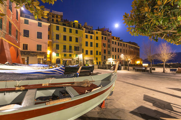 Boats and traditional houses illuminates by moon in the main square of Vernazza, Cinque Terre, Liguria, Italy, Europe.