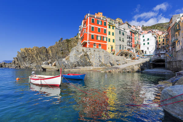 Colourful houses of Riomaggiore is reflected in the water. Cinque Terre, Liguria, Italy, Europe.