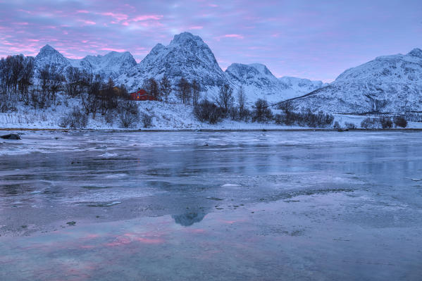Sunrise near a frozen river that flows into Balsfjorden. Storsteinnes, Balsfjorden, Lyngen Alps, Troms, Norway, Lapland, Europe.