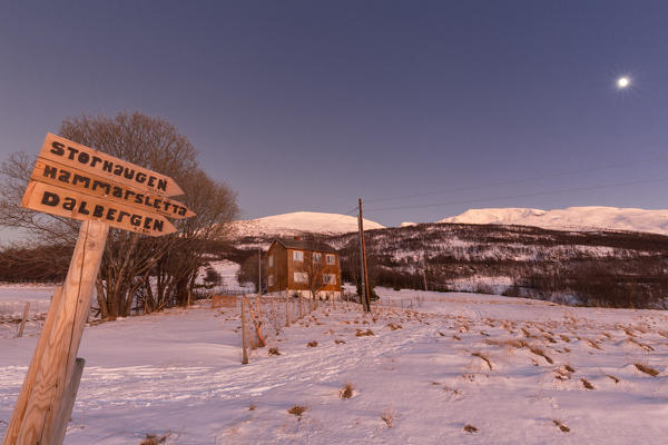 Information for hiking the peaks overlooking the fjord with traditional house during twilight. Hammarvika, Lyngenfjord, Lyngen Alps, Troms, Norway, Lapland, Europe.