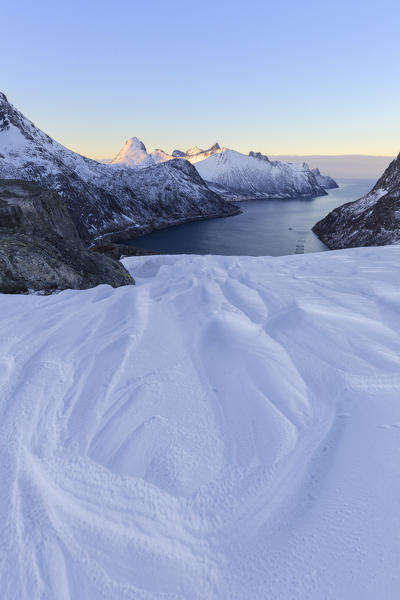 Snow molded by the wind near the Devensattel, a mountain pass that overlooks the Oyfjorden. Barden, Mefjordbotn, Mefjorden, Senja, Norway, Europe.