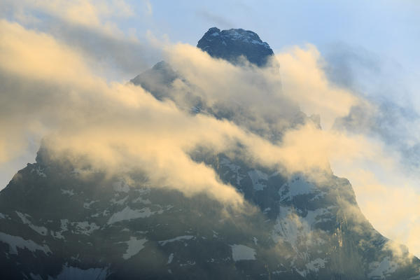 The sun illuminates the clouds surrounding the Matterhorn. Cervinia, Valtournanche, Aosta valley, Italy, Europe