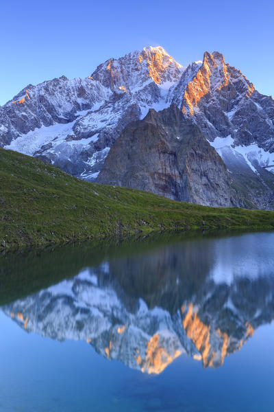 The Mont Blanc is reflected in Lac Checrouit during sunrise. Checrouit Lake, Veny Valley, Courmayeur, Aosta Valley, Italy, Europe