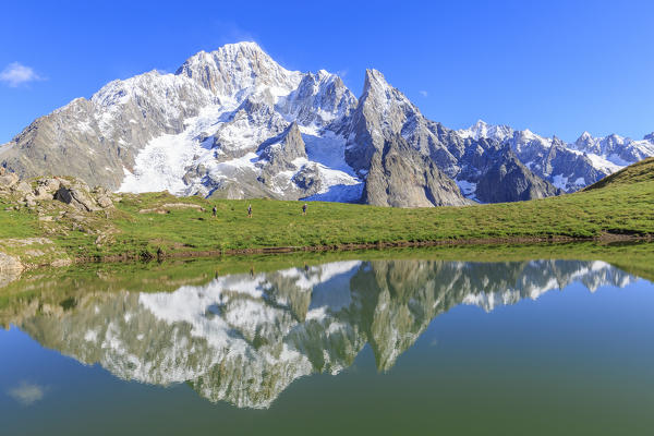 Trail runners in transit at the Lac des Vesses. Vesses Lake, Veny Valley,Courmayeur,  Aosta Valley, Italy, Europe