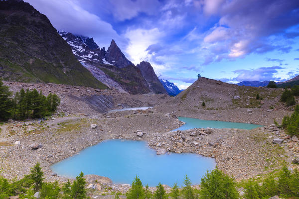 Clouds leave the place to the clear sky above Lake Miage. Miage Lake, Veny Valley, Courmayeur, Aosta Valley, Italy, Europe