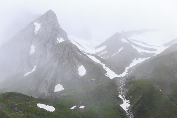 Summer blizzard on Elisabetta Hut and Pyramides Calcares. Elisabetta Hut, Veny Valley, Courmayeur, Aosta Valley, Italy, Europe