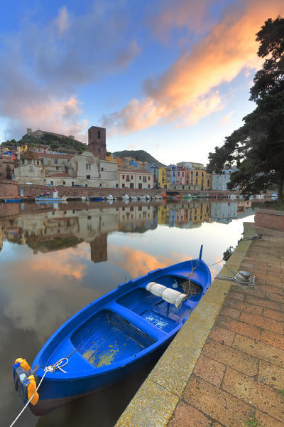 Moored blue boat in the river during sunrise. Bosa, Oristano province, Sardinia, Italy, Europe.