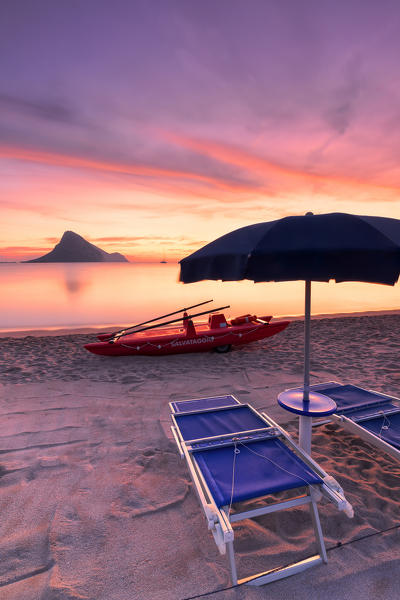 Amazing sunrise on the beach of Porto Taverna with the Tavolara Island in the background. Loiri Porto San Paolo, Olbia Tempio province, Sardinia, Italy, Europe.
