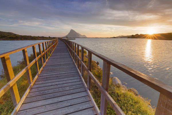 Sunrise from a pedestrian walkway. Porto Taverna, Loiri Porto San Paolo, Olbia Tempio province, Sardinia, Italy, Europe.