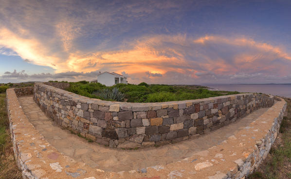 Stunning sunset above a white house. San Pietro Island, Sud Sardegna province, Sardinia, Italy, Europe.