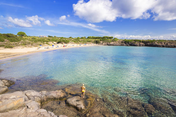 Girl with swimsuit looks the beach. La Bobba Beach, San Pietro Island, Sud Sardegna province, Sardinia, Italy, Europe.