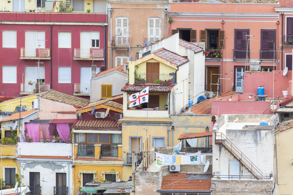 Sardinian flag waving between houses. Cagliari, Cagliari province, Sardinia, Italy, Europe.