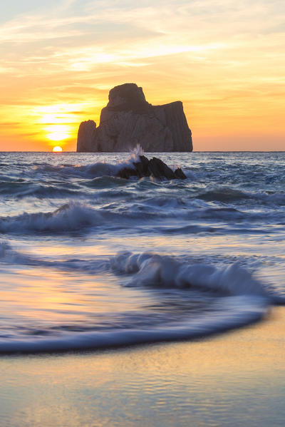 The sunset is reflected on the Beach of Masua, Iglesias, Sud Sardegna province, Sardinia, Italy, Europe.