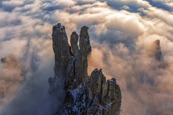 Fungo, Torre, Lancia and Campaniletto towers emerge from the clouds during sunset, Grignetta, Lecco, Lombardy, Italy