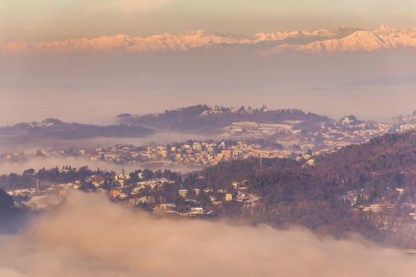 Clouds envelope the Cavallasca village with Alps in the background, Como province, Lombardy, Italy, Europe