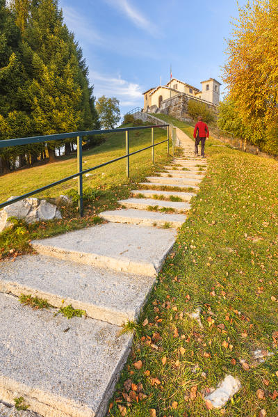 Hiker reaches the Top of Bisbino mount, Como province, Lombardy, Italy, Europe (MR)