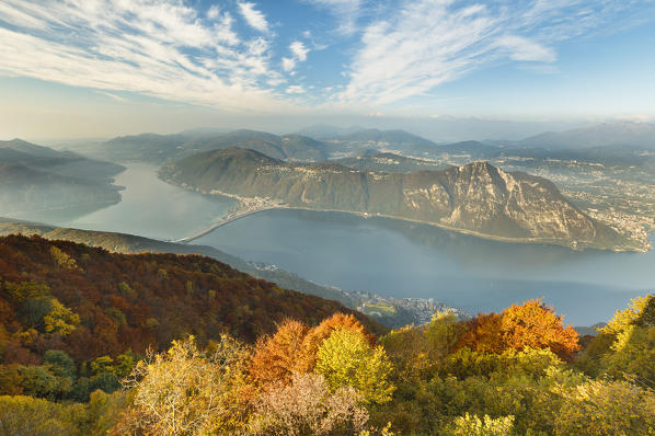 Autumn trees frame Lugano lake (Lugano district, Canton of Ticino, switzerland), view from the Sighignola (Lanzo d'Intelvi, Como province, Lombardy, Italy), Europe