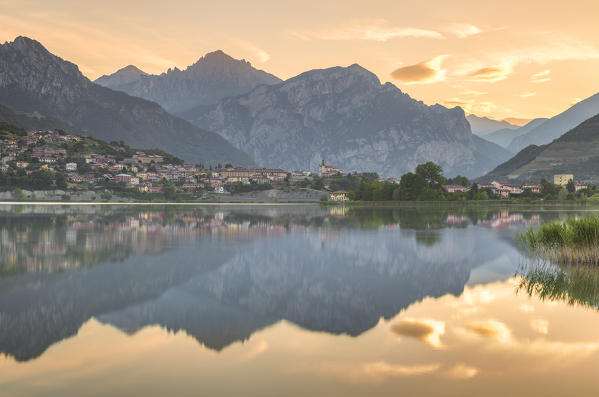 Sunrise on Coltignone mount and Lecco mountains reflected on lake Annone, Lecco province, Brianza, Lombardy, Italy, Europe