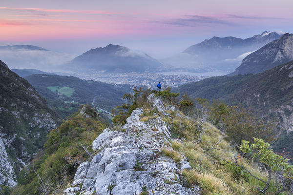 Hiker look a sunrise on Lecco mountains from Morterone, Lecco province, Lombardy, Italy, Europe (MR)