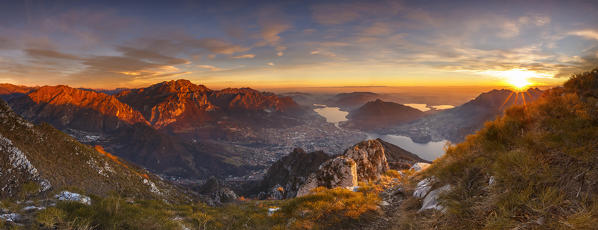 Panoramic of a sunset on Lecco mountains (Resegone, Due Mani) from the top of Coltignone mount, Lecco province, Lombardy, Italy, Europe
