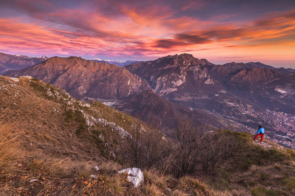 Photographer capture a sunset on Lecco mountains (Resegone, Due Mani) from the top of Coltignone mount, Lecco province, Lombardy, Italy, Europe (MR)