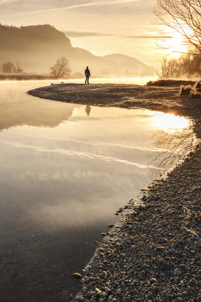 Man admire sunrise on Adda river, Airuno, Brianza, Lecco province, Lombardy, Italy, Europe (MR)