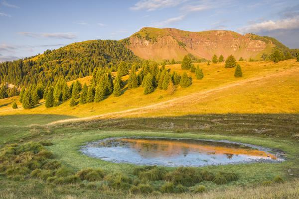 Sunrise on Peller mount reflected into the lake of the Vipers, Cles, Non valley, Trento province, Trentino Alto Adige, Italy, Europe