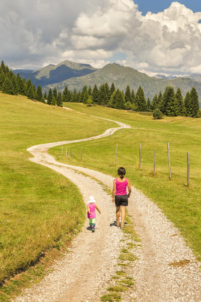 Mom with her daughter walks on the Non valley paths, Cles, Trento province, Trentino Alto Adige, Italy, Europe (MR)