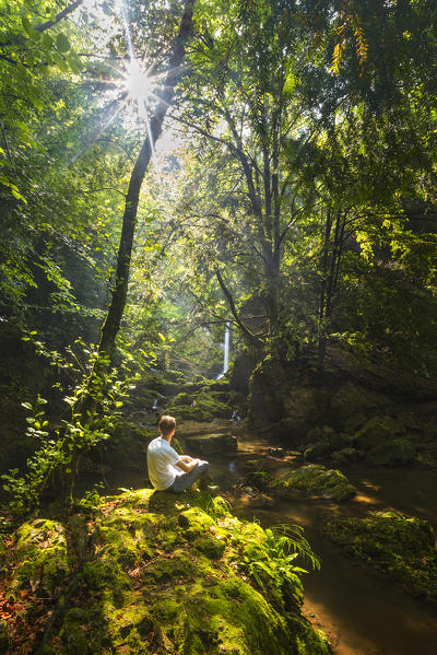 Man looks Fermona waterfall, Ferrera di Varese, Varese province, Lombardy, Italy, Europe (MR)
