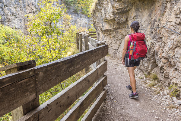 Hiker crosses the canyon to reach San Romedio monastery, sentiero delle forre, Sanzeno, Predaia, Non valley, Trento province, Trentino Alto Adige, Italy, Europe (MR)