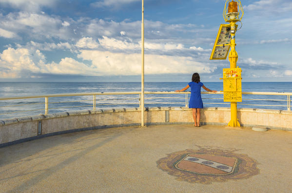 Girl looks the sea on Lido di Camaiore pier, Lucca province, Versilia, Tuscany, Italy, Europe (MR)