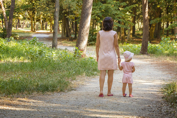 Mom and daughter walking in the pine forest, Pineta di Ponente, Viareggio, Lucca province, Versilia, Tuscany, Italy, Europe (MR)