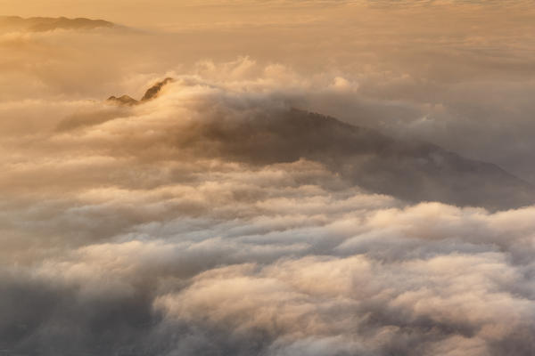 Sunrise on the Barro mount wrapped of clouds, view from the top of Coltignone mount, Piani dei Resinelli, Lecco province, Lombardy, Italy, Europe