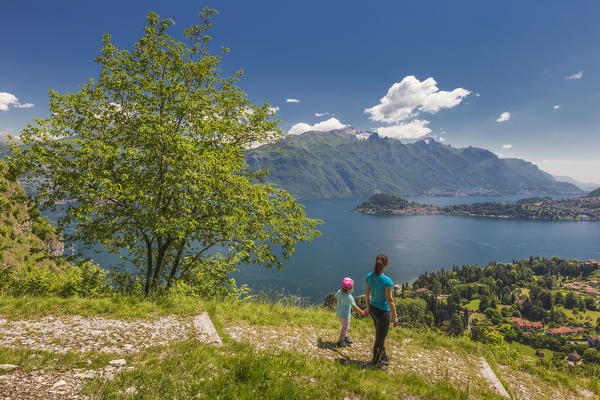 Mom and daughter looking Bellagio and lake Como from the path to San Martino church, Griante, Como province, Lombardy, Italy, Europe (MR)