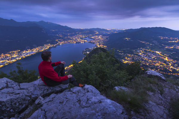 Hiker looks dusk on the top of Barro mount, Garlate lake, Garlate, Galbiate, Vercurago, Brianza, Lecco province, Lombardy, Italy, Europe (MR)