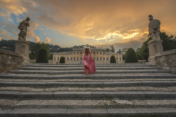 A tourist go up the stairs of Olmo villa at sunset, Como city, Lombardy, Italy, Europe (MR)