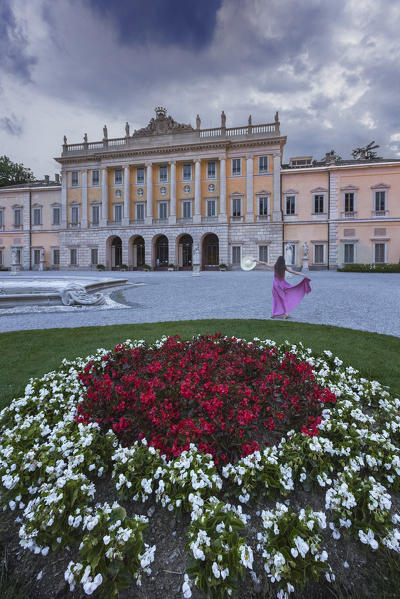 Girl dancing in a Olmo villa garden at dusk, Como city, Lombardy, Italy, Europe (MR)